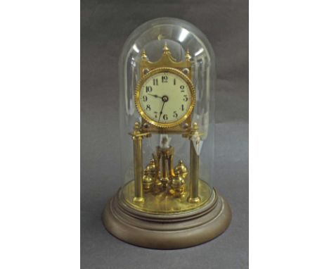 German brass torsion clock under a glass dome, with 2.5" enamel dial, mounted by turrets, no. 119284