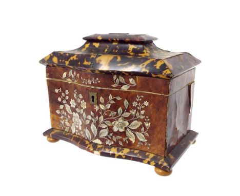 Tortoiseshell serpentine sarcophagus tea caddy, the frieze inlaid with a mother of pearl floral bouquet, the hinged lid enclo