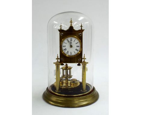 Brass torsion clock, 2.5" enamel dial, with grid pendulum under a glass dome and stand