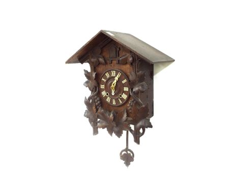 Black Forest two train spring driven cuckoo wall clock striking on a gong, the 6" wooden dial within a carved gabled case, 18