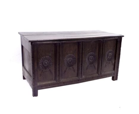 Antique oak four panel coffer, each panel carved with a flowerhead with crossed arrows, 52" long, 26" high