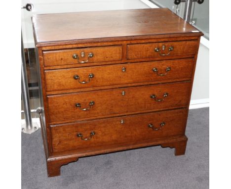 A George III Oak and Mahogany Crossbanded Straight Front Chest of Drawers, late 18th century, the moulded above two short and