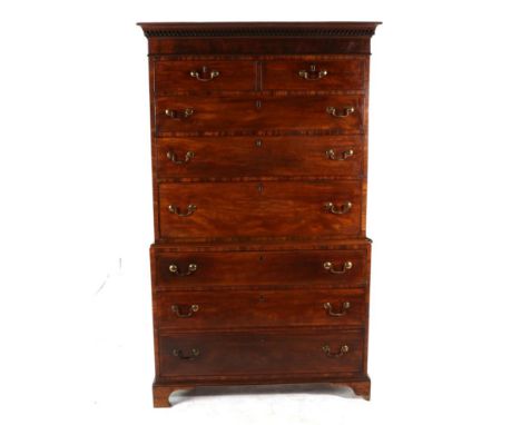 A George III Mahogany Secretaire Chest on Chest, early 19th century, the moulded and zig-zag dentil cornice above two short a