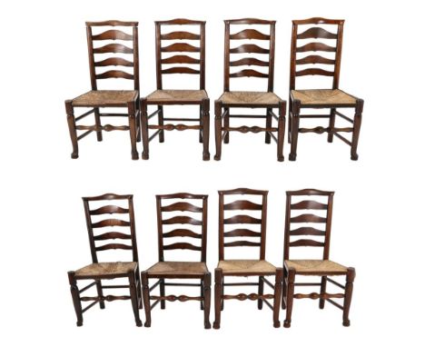 A Set of Eight Late George III Ash and Rush-Seated Ladder-Back Chairs, early 19th century, with hump back top rails, the fore