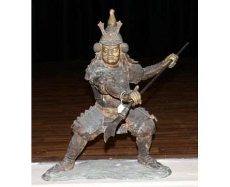 A Japanese Bronze Figure of a Samurai, Meiji period, standing holding a spear in both hands, on a wave form base, 58cm high