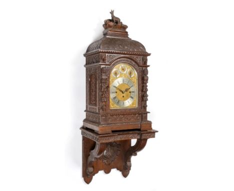 A Carved Oak Chiming Bracket Clock with the Original Wall Bracket, circa 1890, case carved with floral and mask decoration, p