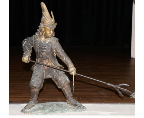 A Japanese Bronze Figure of a Samurai, Meiji period, standing holding a three-prong spear in both hands, on a wave form base,