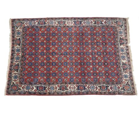 Veramin Carpet  Central Iran, circa 1930 The brick red field of MIna Khani design enclosed by ivory borders of samovar motifs