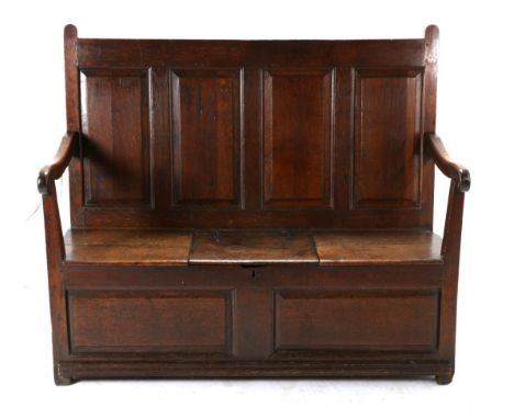 A George III Oak Panel-Back Settle, late 18th century, with four fielded panels above downswept arms and boarded seat centred