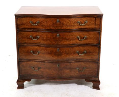 A Mahogany Serpentine Front Chest of Drawers, the top drawer flanked by a small drawer with three graduated drawers below, on