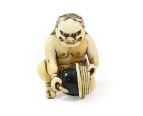 A Japanese Ivory Netsuke, Edo period, as a kneeling Oni holding a half pot, 4cm high  Provenance: Barry Davies Antiques