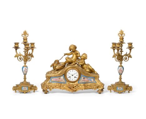 An Ormolu and Porcelain Mounted Striking Mantel Clock with Garniture, circa 1890, surmounted by cherubs holding reins of a sw