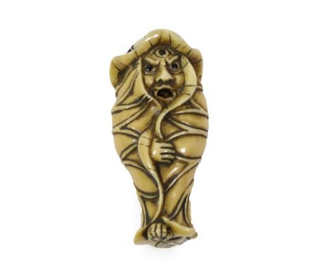 A Japanese Ivory Netsuke, Meiji period, as a Bakemono wrapped in lotus leaves with articulated tongue, 7.5cm high  