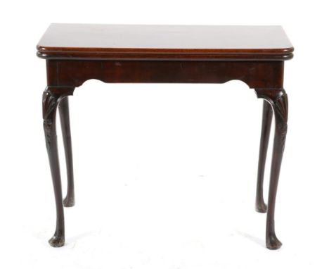 A George III Mahogany Foldover Card Table, circa 1760, with modern green baize interior, the arched frieze on shell carved an