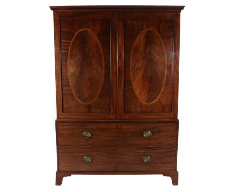 A George III Mahogany and Tulipwood Banded Linen Press, late 18th century, the dentil cornice above oval panel doors, the int