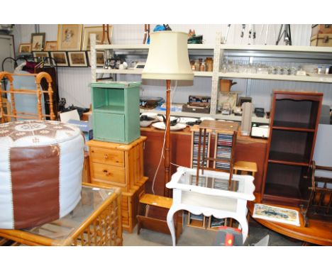 A magazine rack and a standard lamp and shade