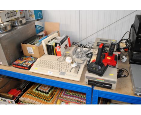 A Commodore 64 keyboard, disc drive, data recorder, two joysticks, cables, various games and software 
