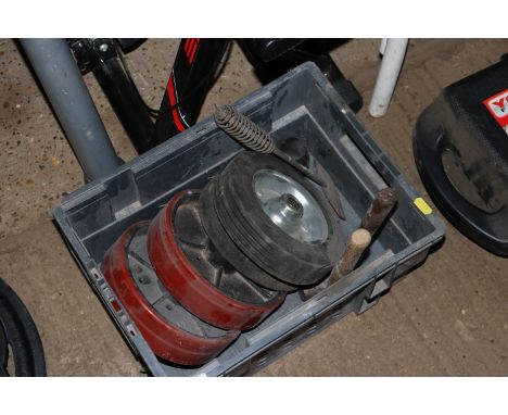 A box containing trolley wheels and hand tools