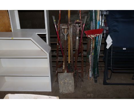 A quantity of long handle garden tools and a step ladder