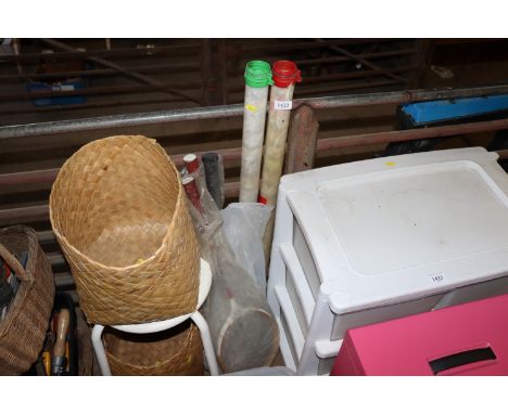 A stool; wicker baskets golf balls and sporting equipment 