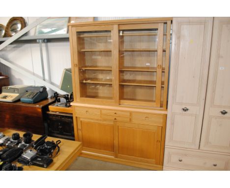 A modern light oak and glazed dresser