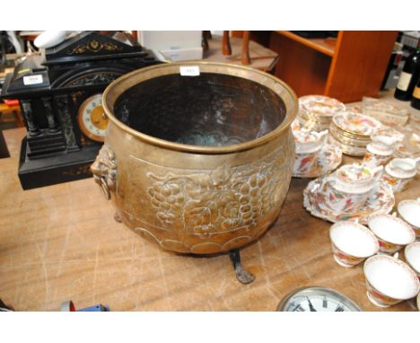 A brass jardiniere with lion marked ring handles