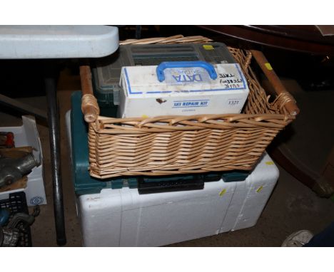 A wicker basket and contents of a toolbox and a ski care kit