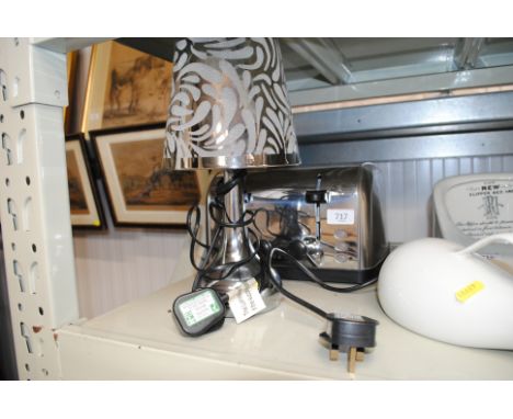 A Russell Hobbs four slice toaster and a table lamp