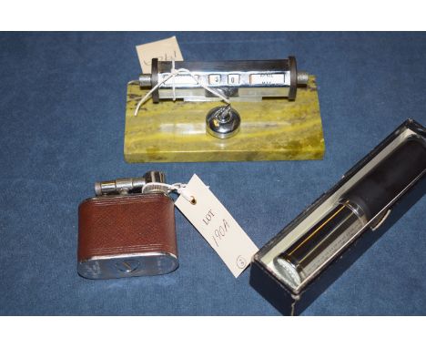 A Cyclops table lighter; together with a desk top calendar with chrome curling stone, on onyx base; and an Otis King calculat