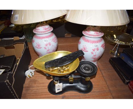 A pair of modern table lamps decorated with figures and foliage; together with brass scales.  (3)