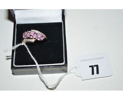 A pink sapphire and diamond ring set, with seven oval facet-cut pink sapphires surrounded by diamonds, on a 9ct. yellow gold 