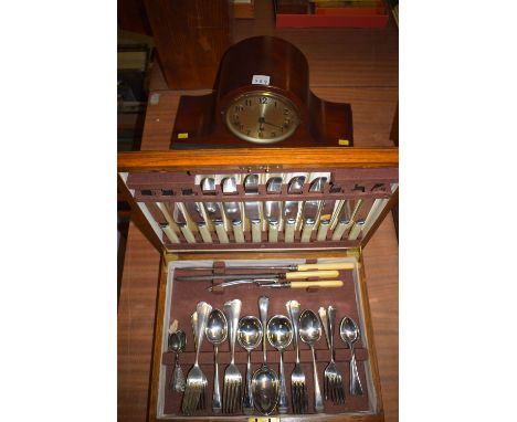 An early 20th Century mantel clock with arabic dial, in mahogany case; together with a canteen of cutlery, Hanoverian pattern