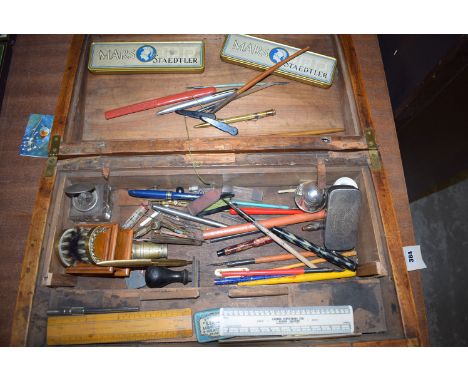 A Victorian walnut writing slope (interior missing), containing collectables, including: calligraphy pens; fountain pens; rul