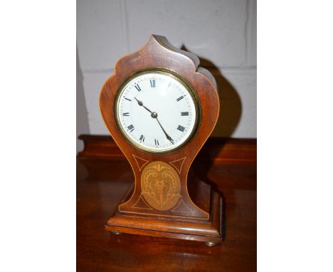 An Edwardian inlaid mahogany balloon cased mantel clock with Roman enamel dial.