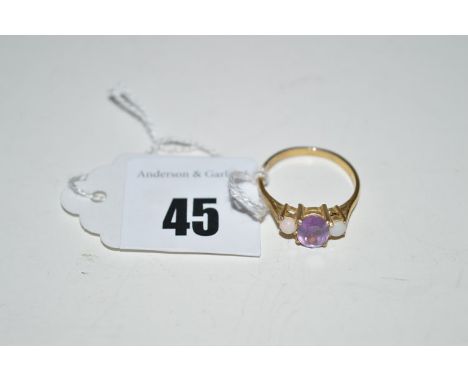 An amethyst and opal ring, on yellow metal shank, ring size N.