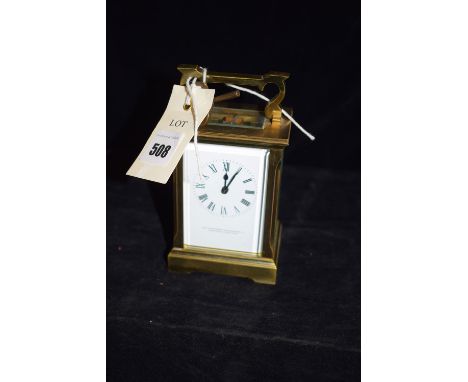 A brass carriage clock with enamel dial, by The Northern Goldsmiths Company, Newcastle upon Tyne (not winding).