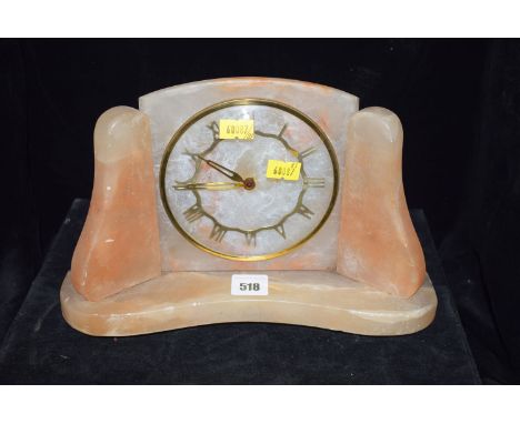 A pink alabaster mantel clock, roman dial by Metamec, Dereham.