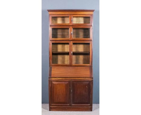 A 1930's mahogany sectional bookcase, the upper part with moulded cornice and three sectional bookcases of graduating sizes, 