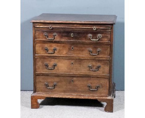 A mahogany bachelors chest of "Georgian" design with moulded edge to top, fitted slide and four long graduated drawers, on br