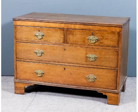 A late Georgian oak chest with twin reeded edge to top, fitted two short and two long drawers, on bracket feet, 41ins wide x 