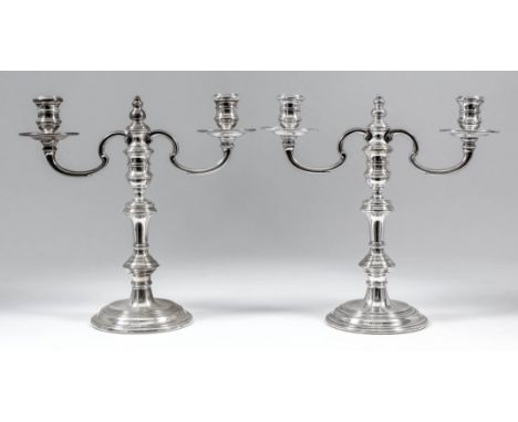 A pair of Elizabeth II silver two light candelabra, the knopped stems with twin C-scroll branches, on circular moulded bases,