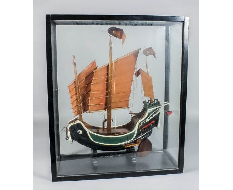 An early 20th Century painted wood model of a junk, circa 1931, 19ins wide x 22ins high, on shaped base on which is painted -