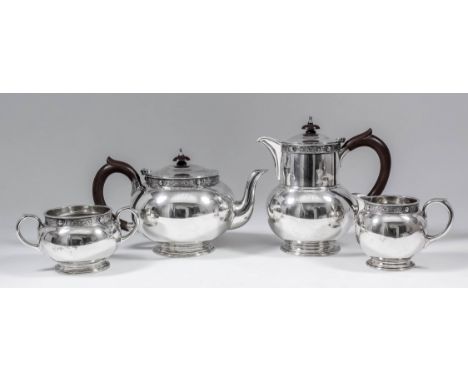 A George VI silver four piece tea service of spherical form, the rims cast with band of Celtic motifs, with C-scroll handles,