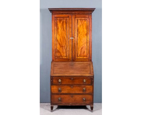 A late George III mahogany bureau cabinet, the upper part with moulded and spiral reeded cornice, fitted two adjustable shelv