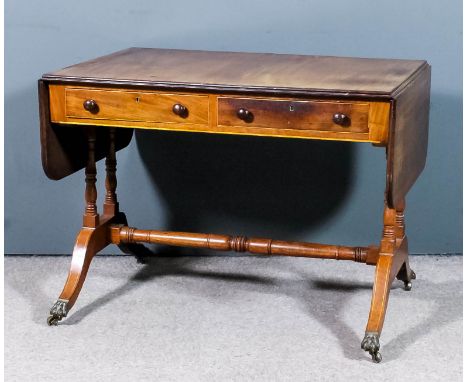 A mahogany sofa table with twin reeded edge to top, fitted two real and two dummy drawers, on twin turned end supports, splay