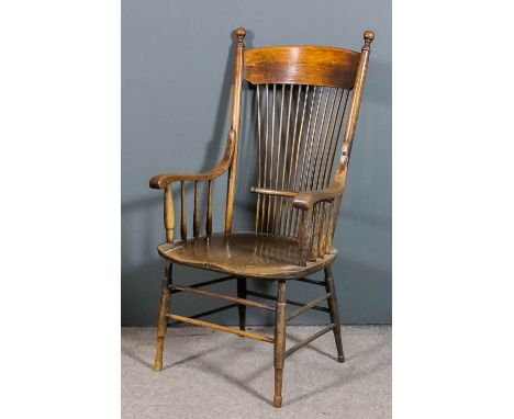 A late 19th Century Armerican oak stick back armchair with curved crest rail, dished seat and on turned legs