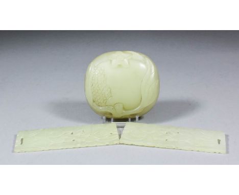 A Chinese celadon jade oval box lid carved with leaves, flower and fruit, 3ins (7.5cm) x 2.75ins (7cm) x .87ins (2.2cm) high 