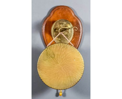 A brass gong by William Tonk & Sons, 12ins diameter, on eagle pattern bracket with a snake in its beak, mounted on oak shield