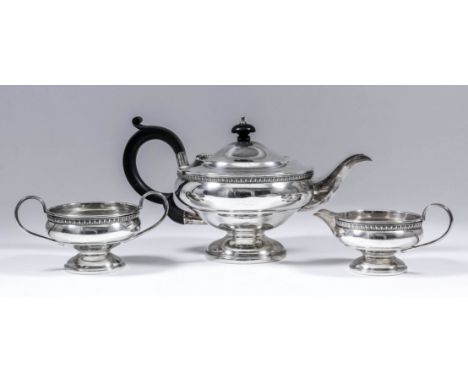 A George V silver circular three piece tea service of bulbous squat form, with egg and dart mounts, C-scroll handles, on circ