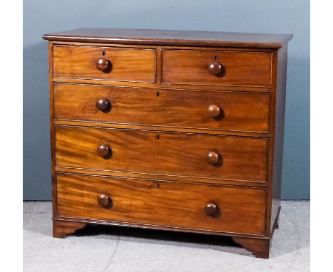 A late Georgian mahogany chest with rounded edge to top, fitted two short and three long drawers, on bracket feet, 42ins wide